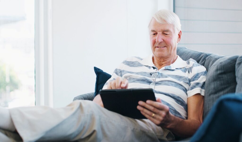 older man looking at tablet